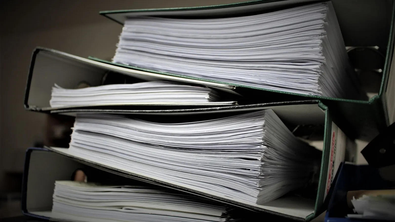 Stacked binders full of documents